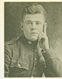 Black-and-white portrait of a man in a military uniform, resting his head on his hand, conveying a contemplative expression. The uniform features a high collar and buttons.