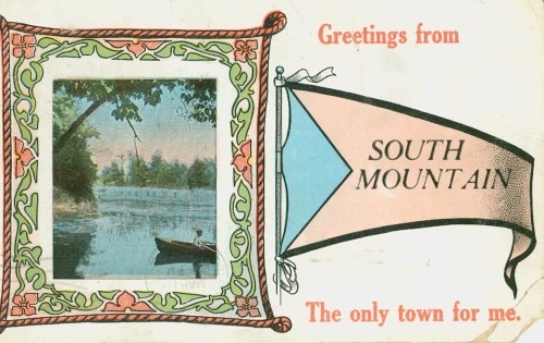 A vintage postcard features a serene lake scene with a boat framed by ornate leaves. Beside it, a banner reads "Greetings from South Mountain."