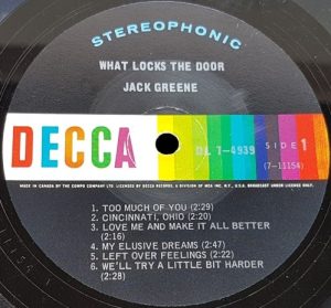 Close-up of a Decca vinyl record label featuring "What Locks the Door" by Jack Greene. Lists six tracks. Bright, multicolored Decca logo.