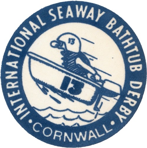 Patch design shows a person in a bathtub-shaped boat navigating waves. Text reads "International Seaway Bathtub Derby, Cornwall." Playful, adventurous theme.