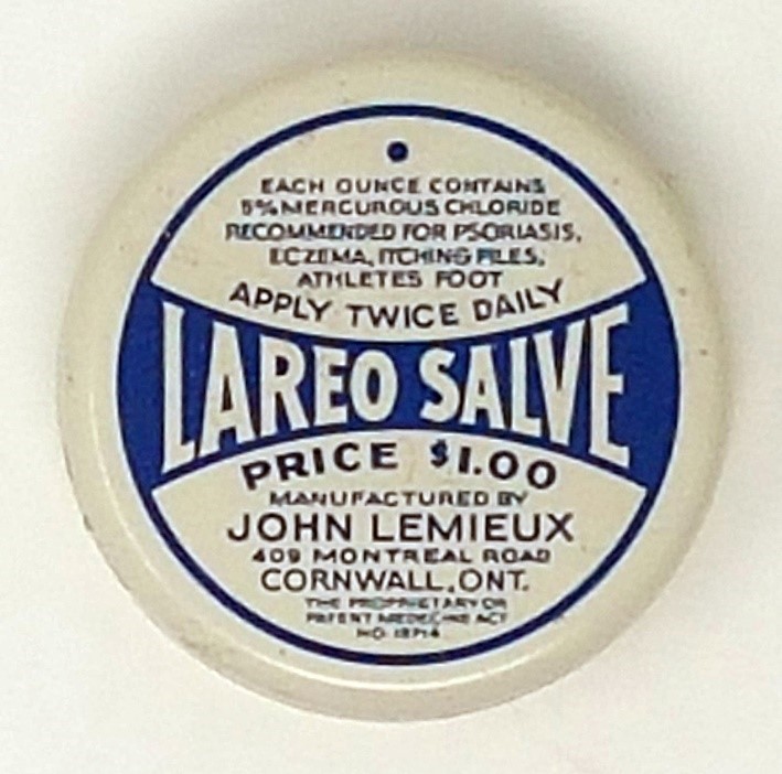 Round white tin labeled “Lareo Salve” with a blue design, price $1.00, instructions for use, and manufacturer info from Cornwall, Ontario.